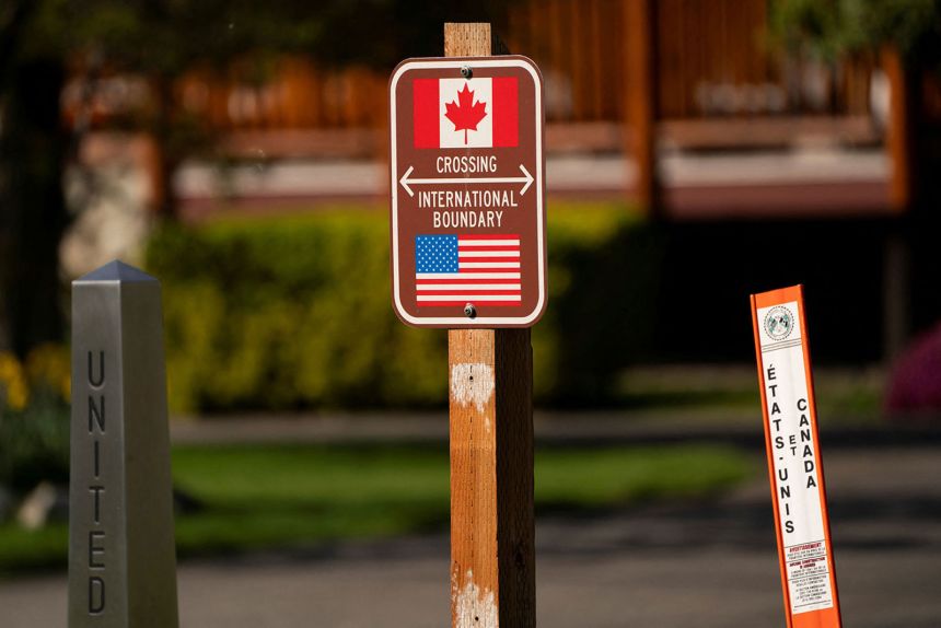 Signs mark the international boundary at a Canada-US border crossing known as the Peace Arch Border Crossing, on the day President Donald Trump announced new tariffs, in Blaine, Washington, on April 2, 2025.