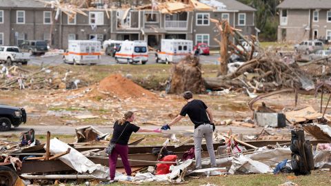 Jesse Furman is handed one of her belongings by Brayden McLemore near her destroyed trailer in Selmer, Tennessee, U.S., after a suspected tornado tore through the town, April 3, 2025.   Chris Day/The Commercial Appeal/USA TODAY NETWORK via Imagn Images via REUTERS  THIS IMAGE HAS BEEN SUPPLIED BY A THIRD PARTY NO RESALES. NO ARCHIVES MANDATORY CREDIT