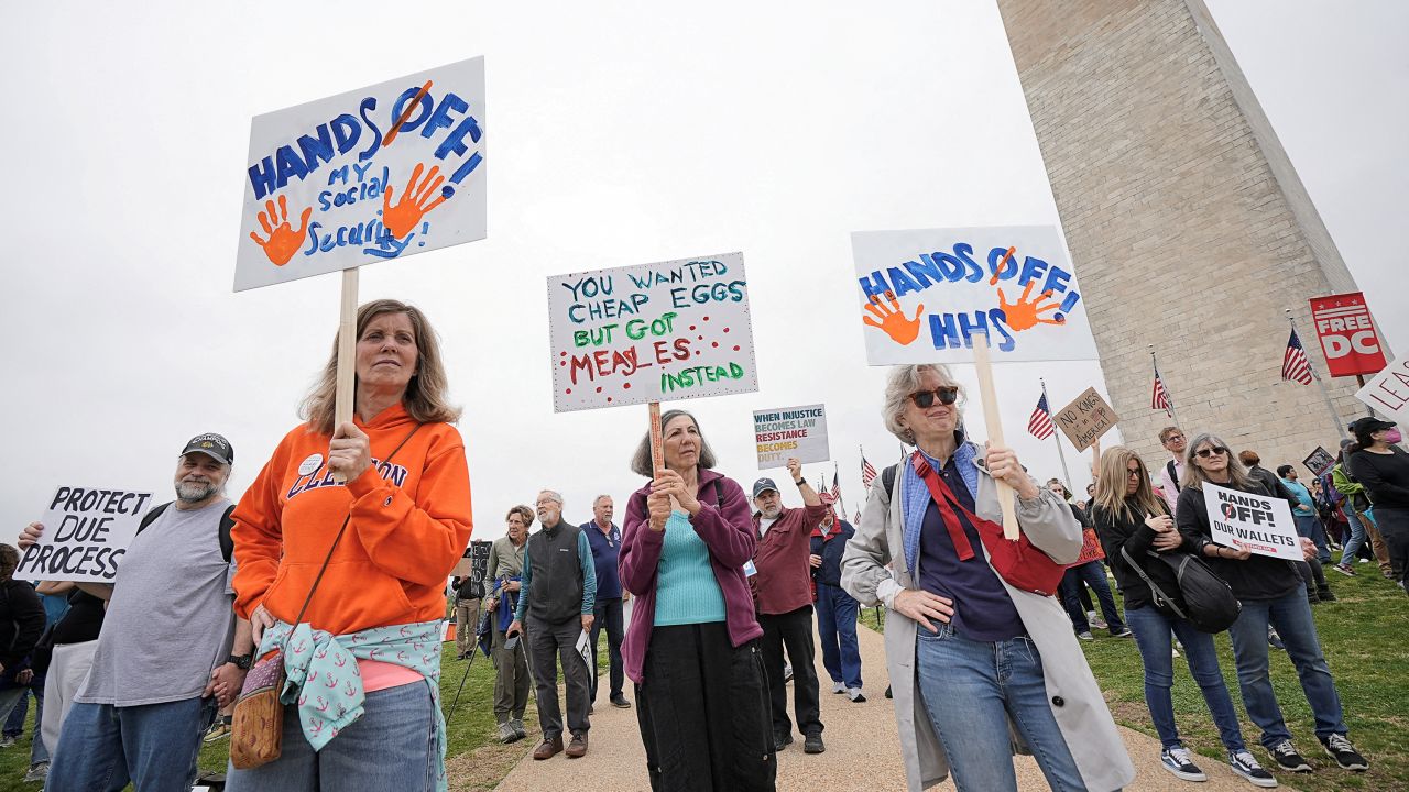 Demonstrators rally against U.S. President Donald Trump and his adviser Elon Musk during a 'Hands Off!' protest on the Washington Monument grounds, in Washington, D.C., U.S., April 5, 2025.
