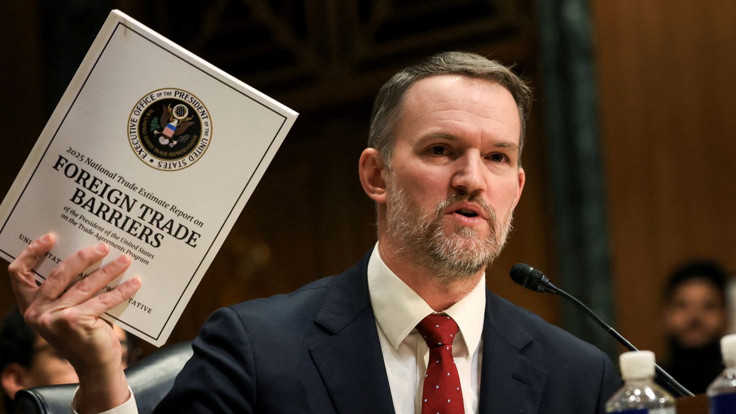 U.S. Trade Representative Jamieson Greer holds a copy of "Foreign Trade Barriers" as he testifies before a Senate Finance Committee hearing on U.S. President Donald Trump's trade policy, on Capitol Hill in Washington, D.C., U.S., April 8, 2025.