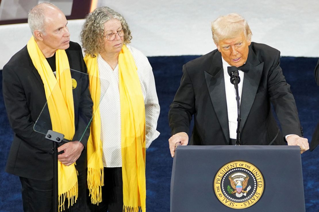 President Donald Trump speaks next to Keith Siegel and Aviva Siegel during the National Republican Congressional Committee dinner at the National Building Museum in Washington, DC, on April 8.