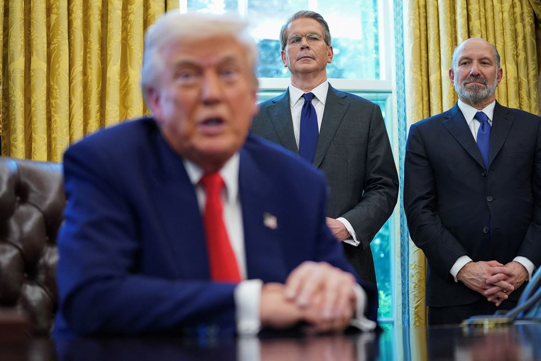 US Commerce Secretary Howard Lutnick and Secretary of the Treasury Scott Bessent stand as President Donald Trump signs executive orders.