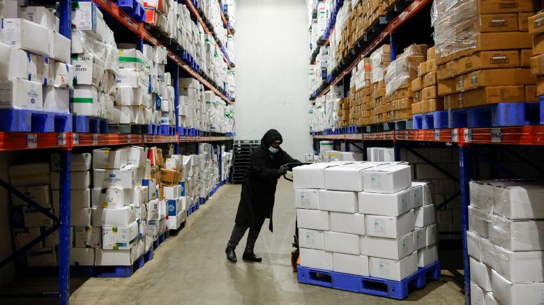 A worker pushes a cart of packaged frozen shrimp at a factory on the outskirts of Vishakhapatnam, India.