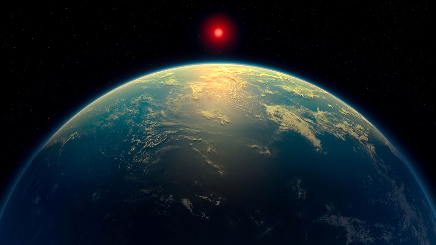 An illustration shows a hycean world – an exoplanet with a liquid water ocean beneath a hydrogen-rich atmosphere – orbiting a red dwarf star. Based on observations by the James Webb Space Telescope, the exoplanet K2-18 b might fit in this category.