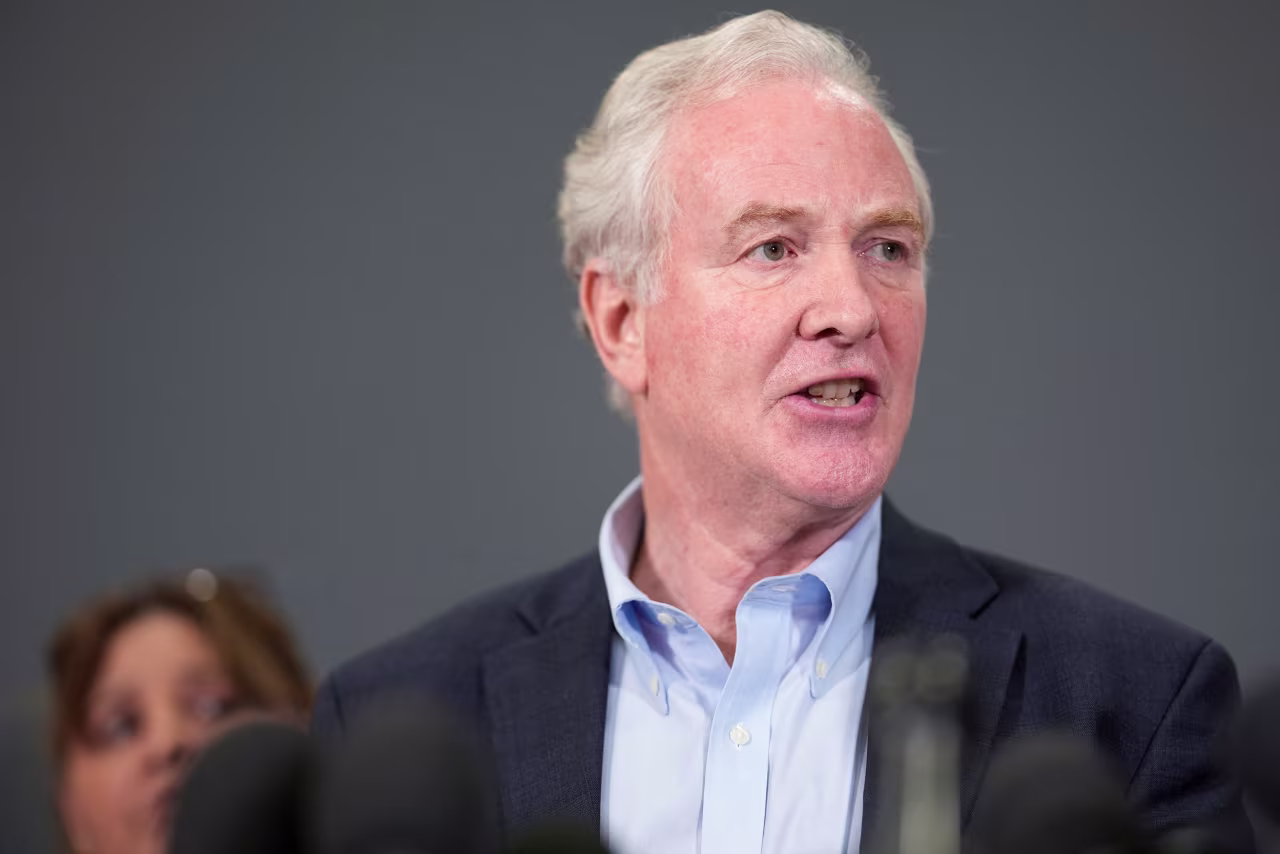 Sen. Chris Van Hollen holds a press conference at Dulles International Airport in Virginia on Friday.