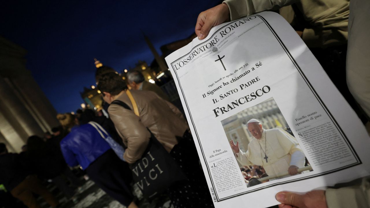 A person holds a "L'Osservatore Romano" newspaper with a picture of Pope Francis, following the death of the Pontiff, in the Vatican, April 21, 2025. REUTERS/Kai Pfaffenbach