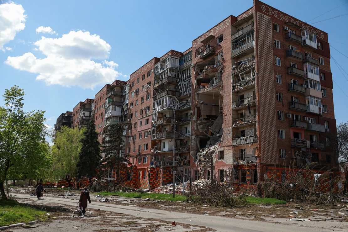 Residents walk next to an apartment building hit by Russian military strikes in Pokrovsk onApril 23, 2025.