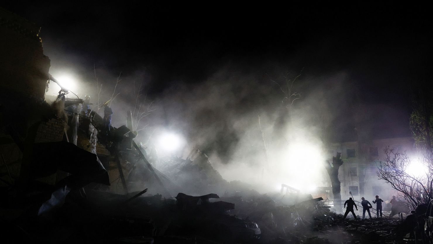 Rescuers work at the site of an apartment building in Kyiv, Ukraine that was hit by a Russian ballistic missile strike on Thursday.