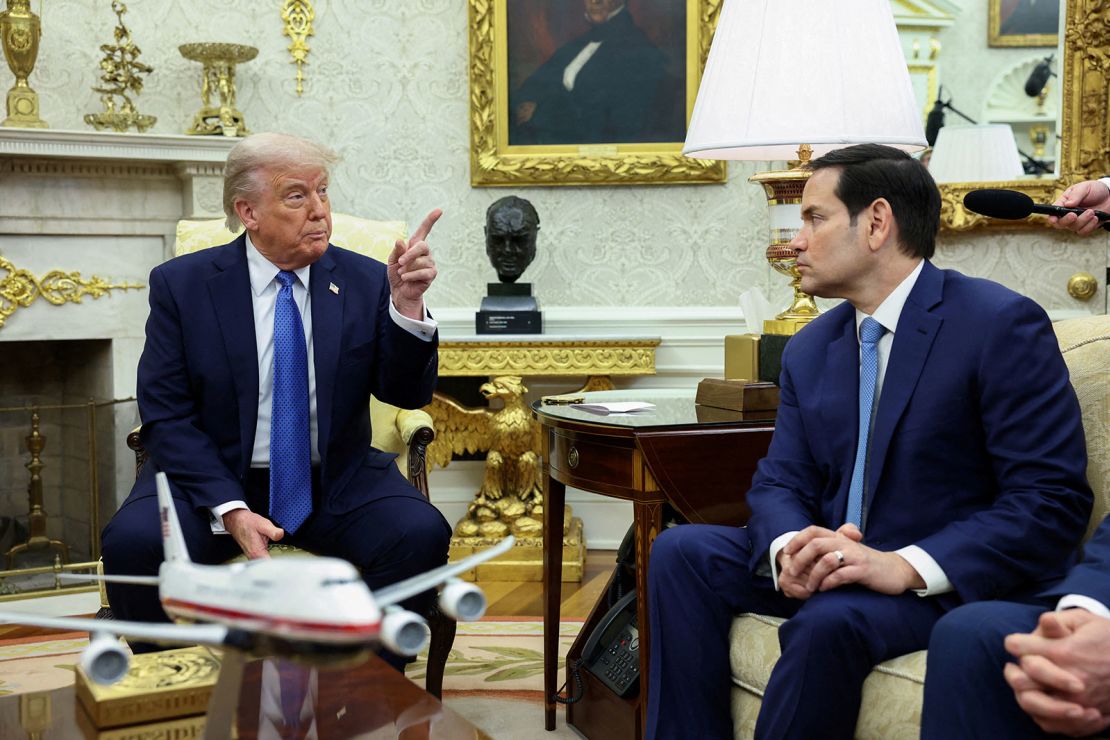 President Donald Trump gestures as Secretary of State Marco Rubio looks on during a meeting with Norway's prime minister (not pictured) in the Oval Office on April 24, 2025.