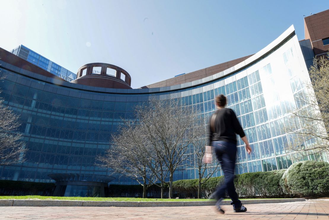 A person walks by the federal courthouse where a judge held an initial hearing April 28 in Harvard University's lawsuit seeking to block the Trump administration's freeze of billions of dollars in federal funding.