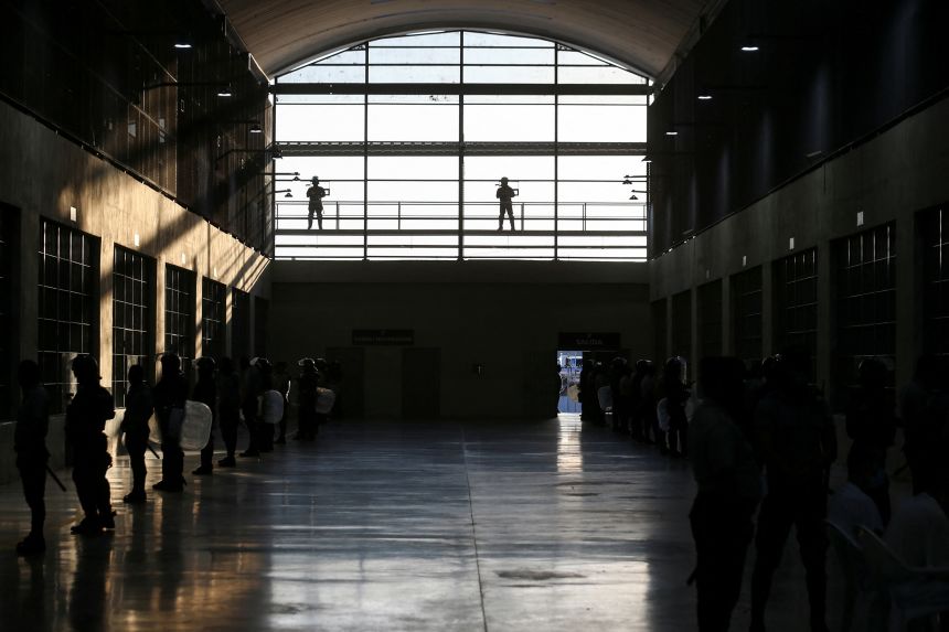 Police officers stand guard at the Terrorism Confinement Center (CECOT) prison, during a media tour, in Tecoluca, El Salvador April 4, 2025.