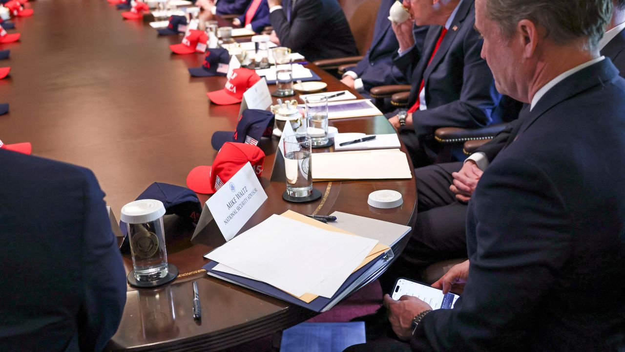 Mike Waltz checks his mobile phone while attending a cabinet meeting held by US President Donald Trump at the White House in Washington, DC, on April 30.
