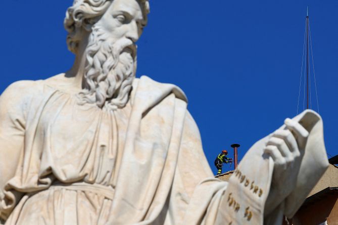 A firefighter works to set a chimney on the roof of the Sistine Chapel at the Vatican on Friday, May 2, ahead of the conclave — the closed-door process to choose Pope Francis’ successor. White smoke will emerge from the chimney when a new pope is elected.
