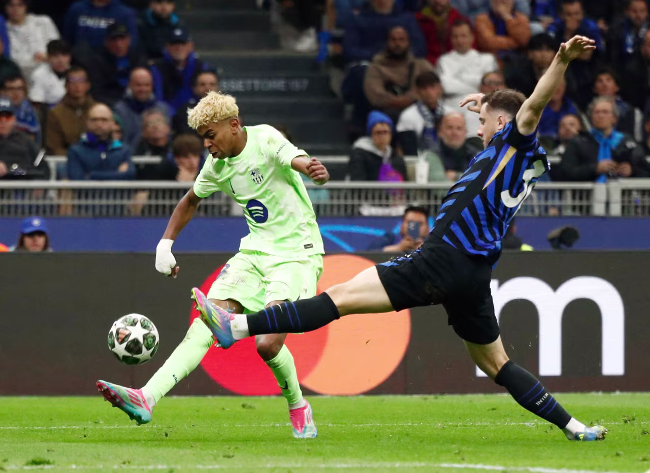 Barcelona's Lamine Yamal, left, in action with Inter Milan's Carlos Augusto.