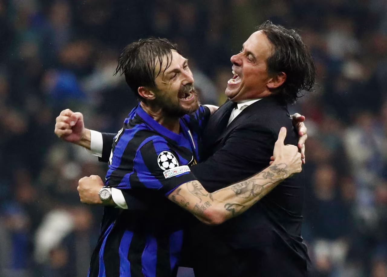 Inter Milan's Francesco Acerbi and coach Simone Inzaghi celebrate after the match.