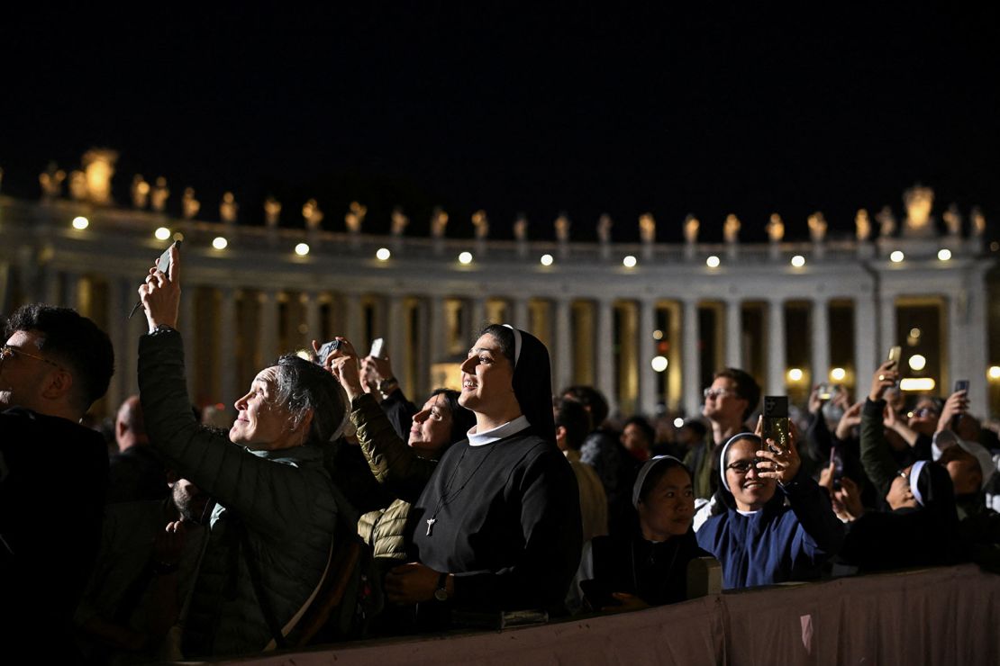 The sun went down before the smoke started billowing, but crowds still waited in the dark to get a glimpse of the Sistine Chapel's chimney.