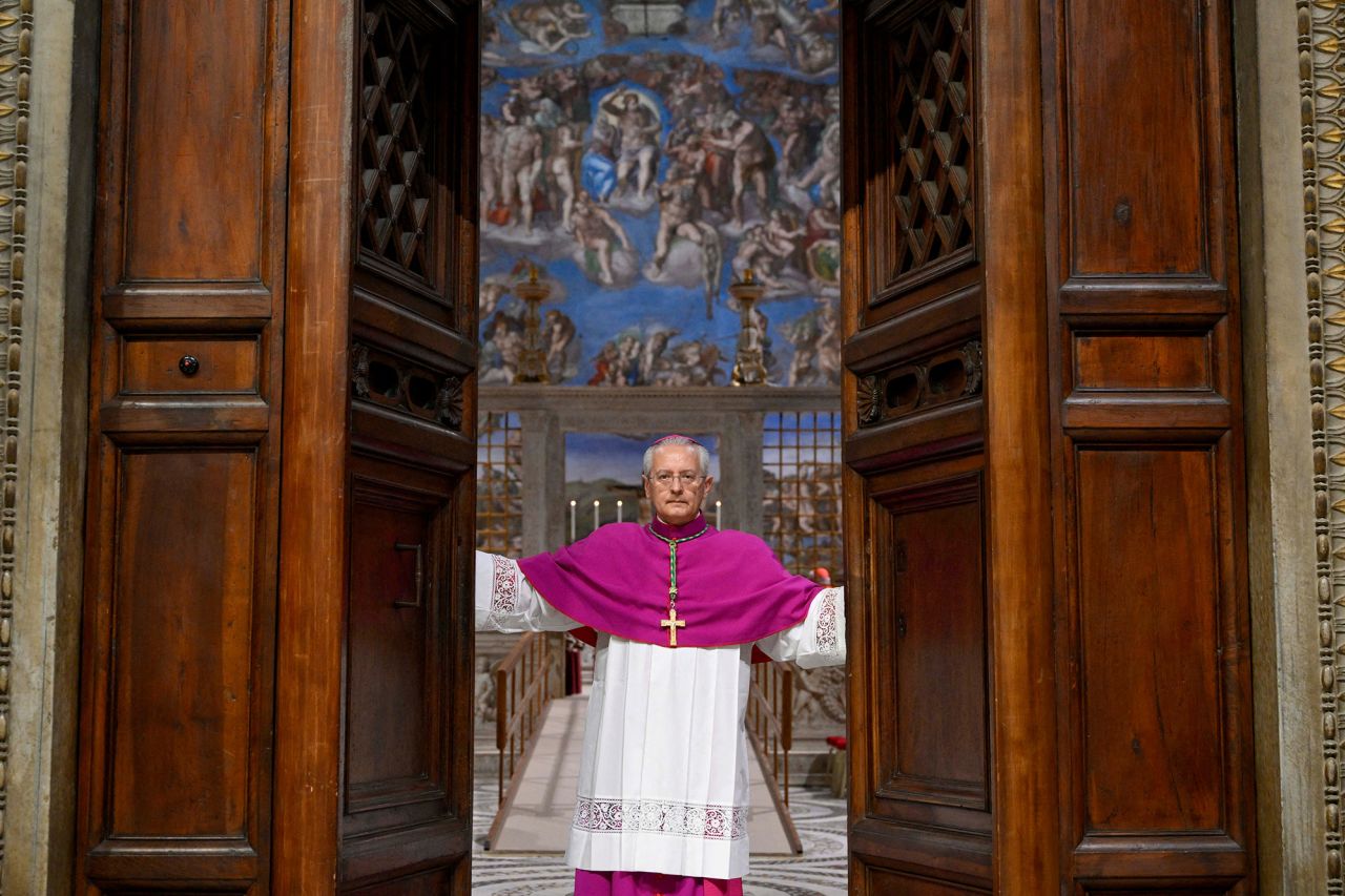 Archbishop Diego Giovanni Ravelli closes the doors of the Sistine Chapel, ahead of the conclave to elect the next pope at the Vatican, on Wednesday.