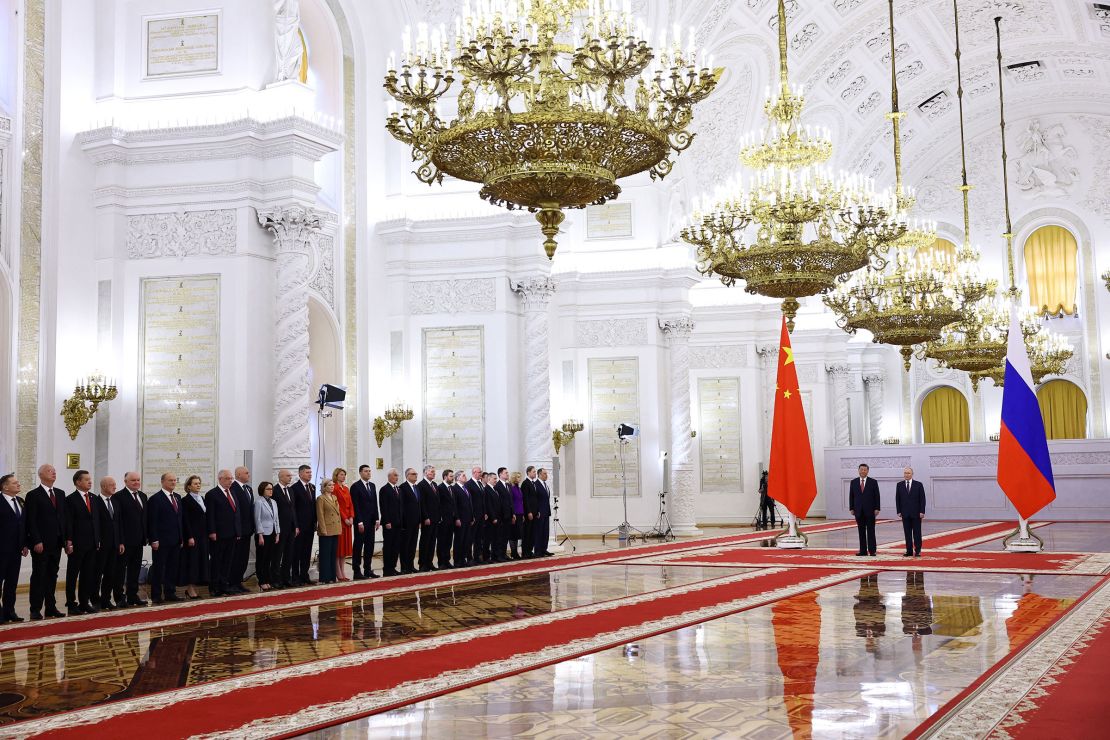 Members of the Chinese and Russian delegations watch Russian President Vladimir Putin welcome Chinese leader Xi Jinping to the Kremlin on May 8.