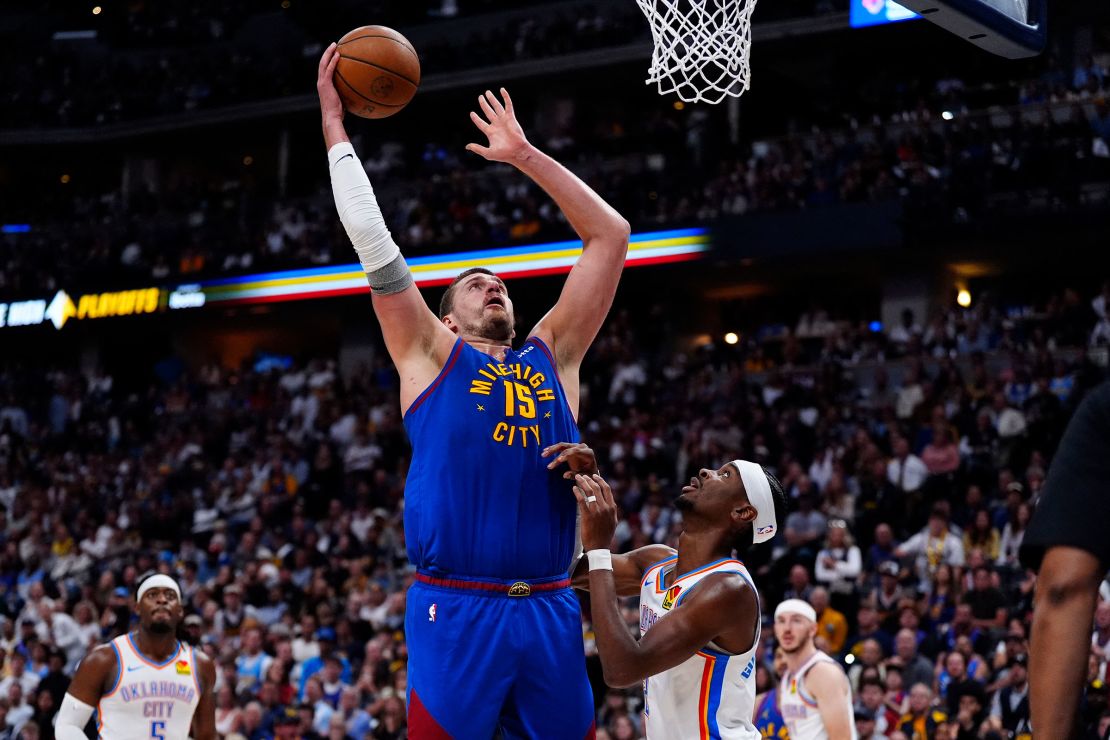 Nikola Jokić shoots the ball over MVP rival Shai Gilgeous-Alexander.