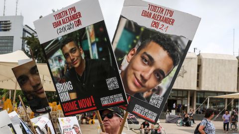 A person holds the pictures of the hostages, on the day Israeli-American hostage Edan Alexander, who was kidnapped during the deadly October 7 attack, is expected to be released from captivity by Hamas in Gaza, in Tel Aviv, Israel May 12, 2025. REUTERS/Ronen Zvulun