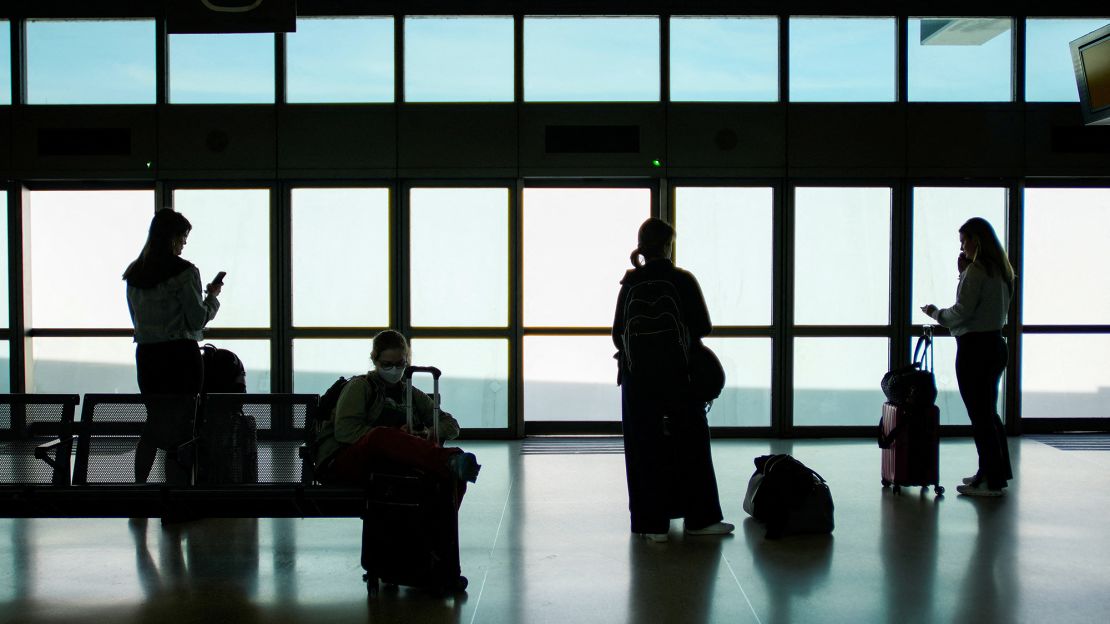 People wait for the air train to connect with their flights after an air traffic control outage, bringing flights to a standstill at Newark Liberty International Airport on May 12, 2025.