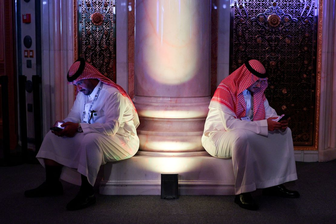 Men use their phones during the Saudi-US Investment Forum, in Riyadh, Saudi Arabia, May 13, 2025.