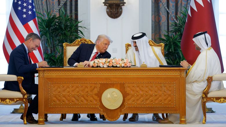 US President Donald Trump, Qatar's Emir Tamim bin Hamad Al Thani and Boeing CEO Kelly Ortberg attend a signing ceremony in Doha, Qatar on May 14, 2025.