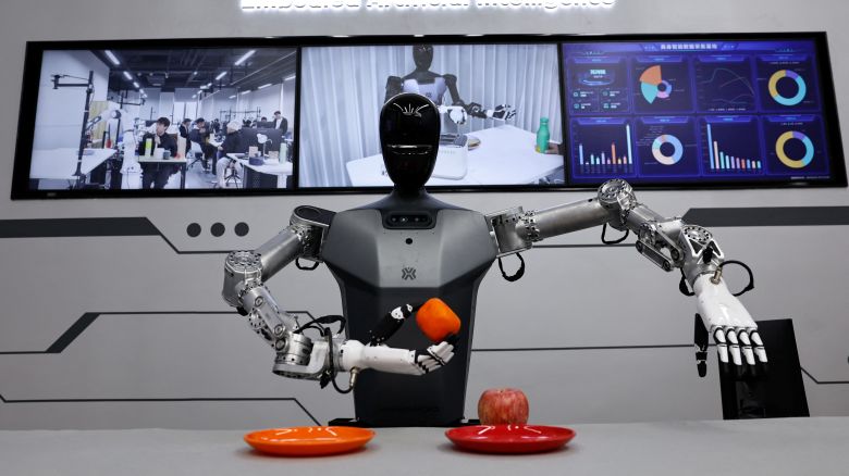 A humanoid robot Tiangong by Beijing Innovation Center of Humanoid Robotics Co, moves an orange as a demonstration at its company, during an organised media tour to Beijing Robotics Industrial Park, in Beijing Economic-Technological Development Area, also known as Beijing E-Town, China on May 16, 2025.