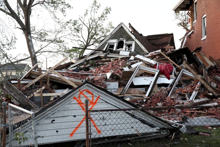 A house lies collapsed under a mountain of bricks, after a tornado struck in St. Louis, on Friday.