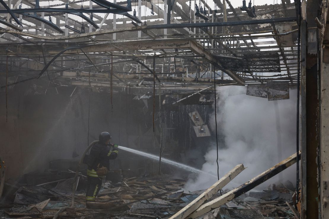 A firefighter works at the site of a Russian drone strike outside of Kyiv.