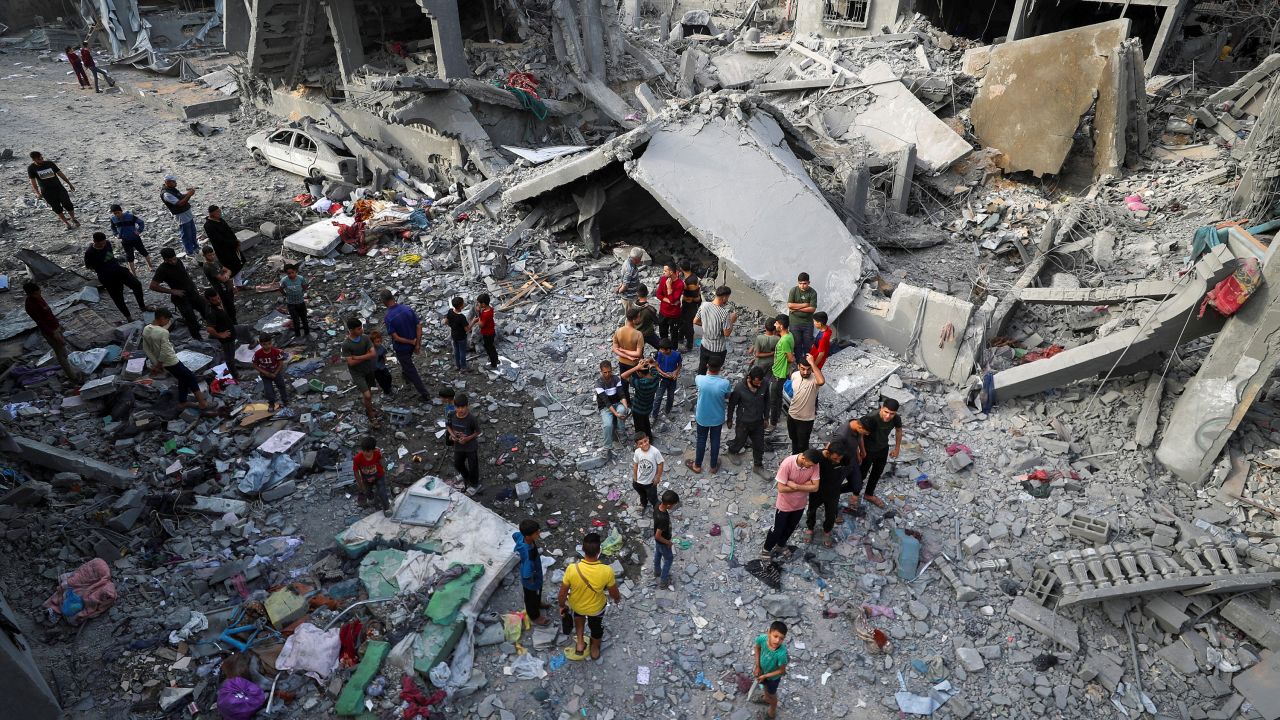 Palestinians inspect the site of an Israeli strike in Jabalya, northern Gaza on May 18, 2025.