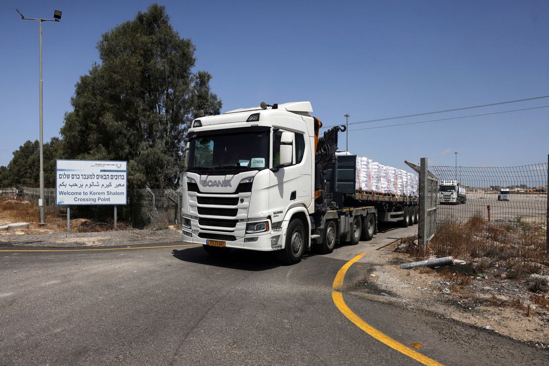 Trucks carrying aid, make their way into Gaza, at the Kerem Shalom crossing, on the Israeli side of the crossing on Monday.
