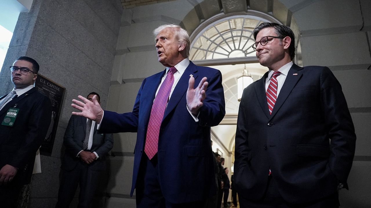 U.S. President Donald Trump gestures next to U.S. House Speaker Mike Johnson (R-LA), on the day of a closed House Republican Conference meeting on Capitol Hill in Washington, D.C., U.S., May 20, 2025. REUTERS/Ken Cedeno
