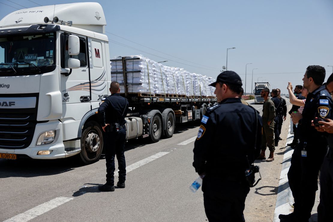 Israeli security forces members stand near trucks with aid entering from Israel into Gaza, near the Kerem Shalom crossing on May 21.