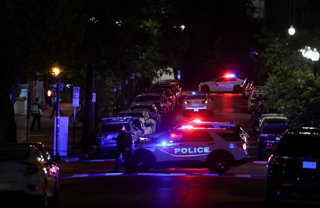 Police officers work at the site of the shooting.