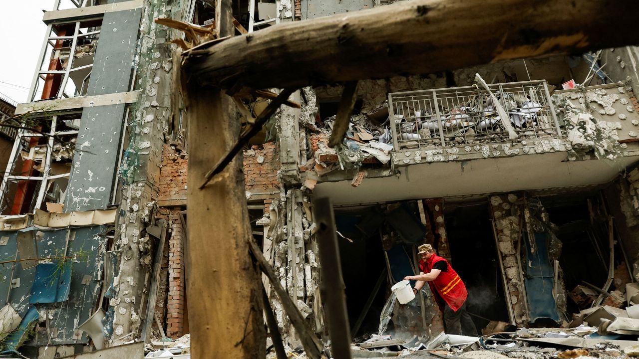 A municipality worker cleans an apartment building that was damaged in a Russian drone strike, amid Russia's attack on Ukraine, in Kyiv, Ukraine, on May 25, 2025.