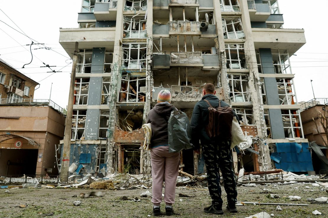 Residents look at an apartment building that was damaged in a Russian drone strike in Kyiv, Ukraine, on May 25, 2025.