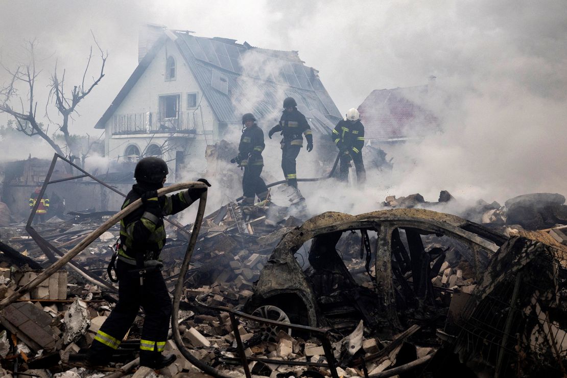Emergency workers extinguish flames in the debris of a private house that was destroyed in a Russian rocket strike in Markhalivka, Kyiv region, Ukraine, May 25, 2025.