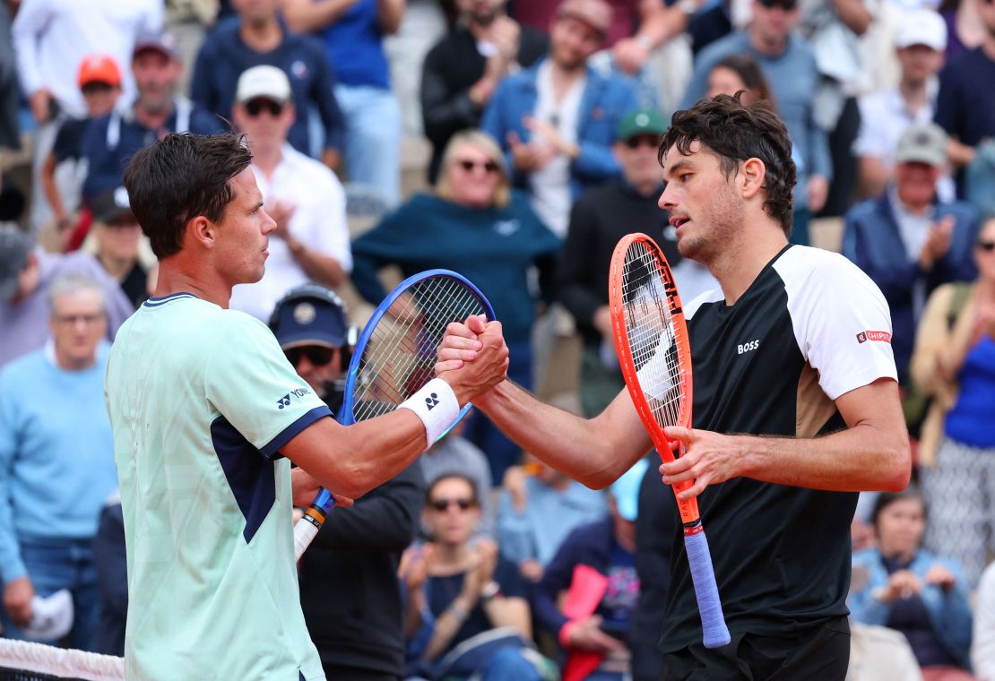 Altmaier (left) and Fritz shake hands after their first-round match.