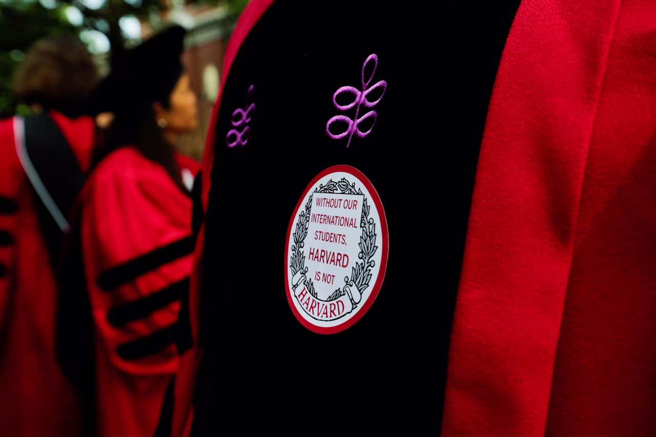 An attendee wears a sticker during the commencement ceremony.