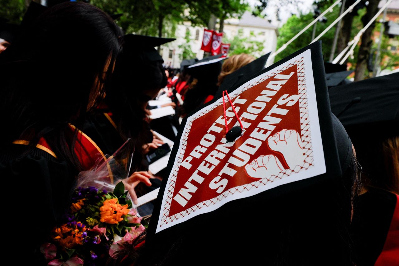 A graduate student wears his punished hat during the ceremony starting at Harvard University on Thursday.
