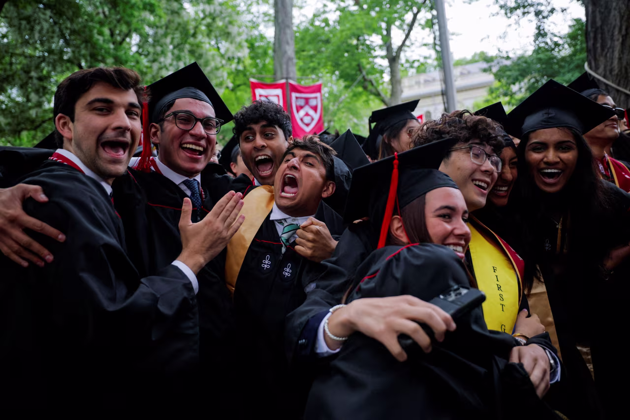 Undergraduate students react as they get their degrees during the commencement ceremony at Harvard University in Cambridge, Massachusetts, on Thursday.