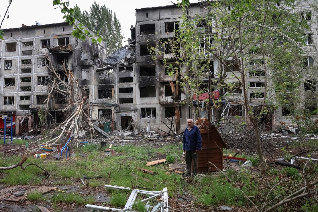 A resident stands near buildings damaged by Russian military strikes in the frontline town of Myrnohrad, Donetsk region, Ukraine May 29, 2025.