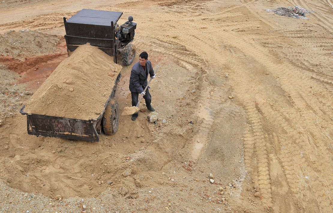 A laborer works at a site of a rare earth metals mine in China's Jiangxi province in 2012.