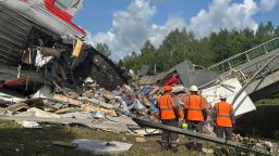 Emergency service workers at the scene of a bridge collapse in Russia's Bryansk region on Sunday.