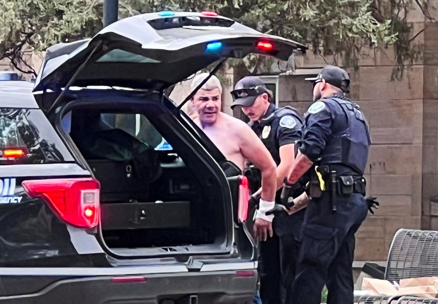 Law enforcement officers detain a suspect in Boulder, Colorado, on Sunday.