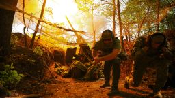 Ukrainian soldiers fire a Howitzer towards Russian troops on a front line in Ukraine's Kharkiv region on Monday.