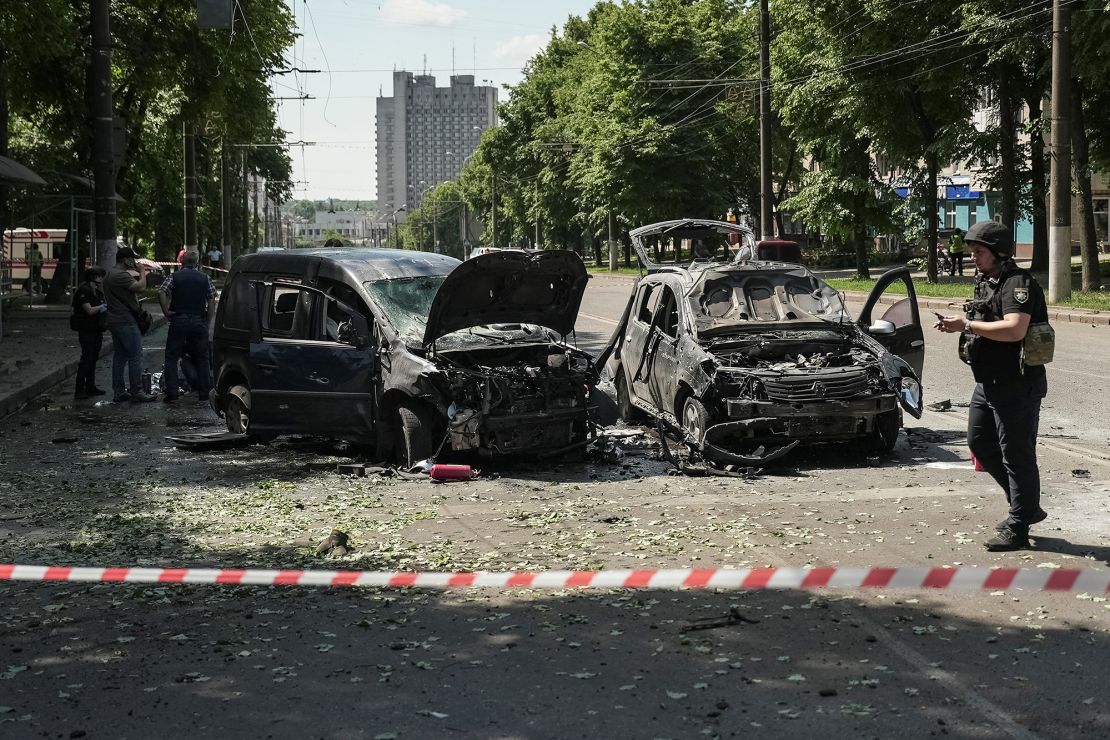 Police officers stand at the site of a Russian missile strike on Sumy on June 3.