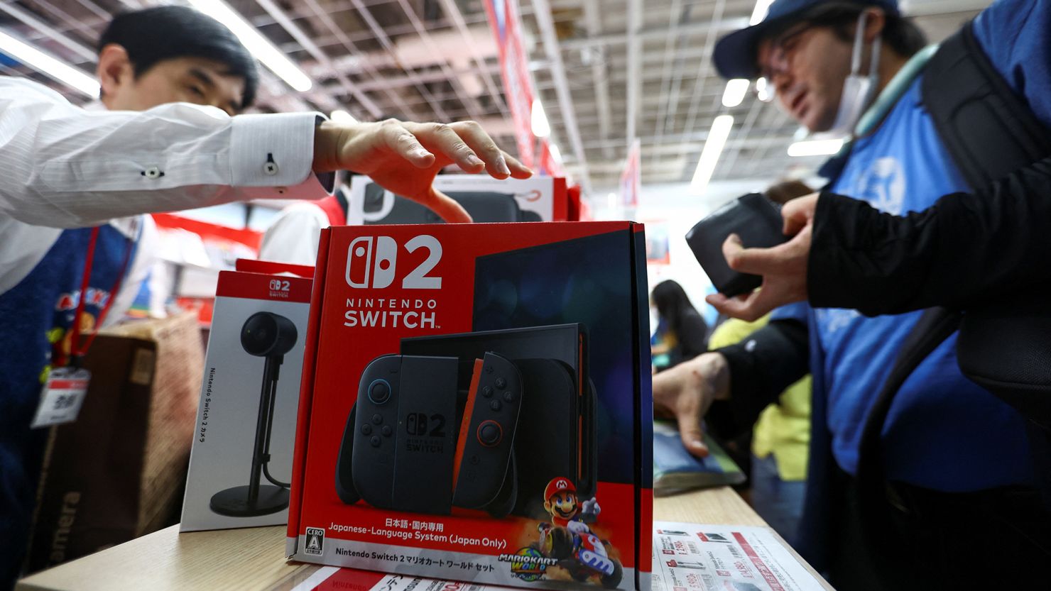 A man buys a Nintendo Switch 2 gaming device as Nintendo starts selling the new consoles globally, at an electronics store in Tokyo, Japan, on June 5.