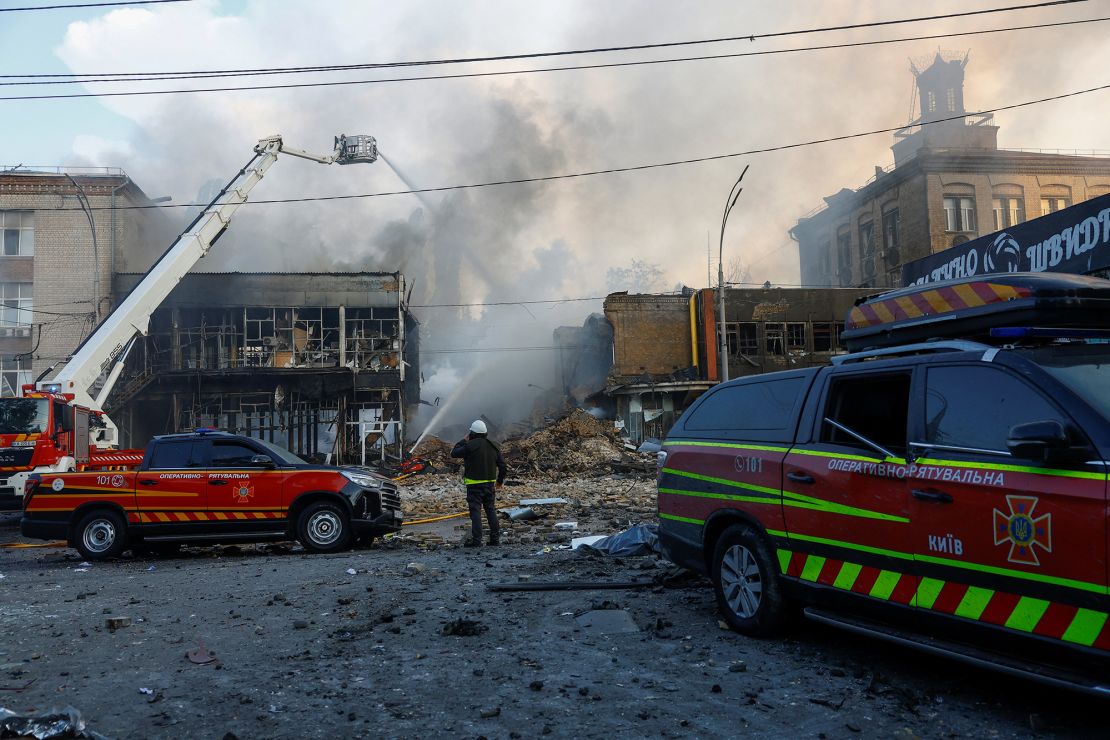 Firefighters respond to a Russian drone and missile strike on Kyiv on Friday.
